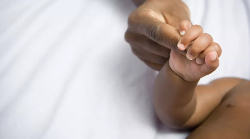 : Illustration of a newborn receiving malaria treatment in a clinic setting, symbolizing groundbreaking infant care innovation.