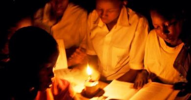 Children studying under candlelight in rural Africa due to lack of electricity